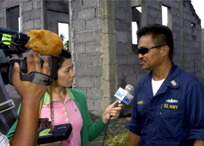 US Navy 070628-N-1752H-035 Master Chief Machinist's Mate Gamaliel Navarro answers questions from local media about what the Navy is doing in support of the Pacific Partnership mission