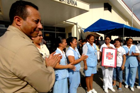 US Navy 070630-N-0194K-151 Lt. Cmdr. Manny Santiago, medical site leader for Military Sealift Command hospital ship USNS Comfort (T-AH 20), claps with outpatient nurses at Puerto Barrios National Hospital