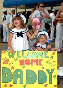 US Navy 070702-N-1522S-004 Two young girls anxiously cheer for their father, Gas Turbine System Technician (Mechanical) 1st Class David Pfister, during the homecoming of guided-missile frigate USS Underwood (FFG 36)