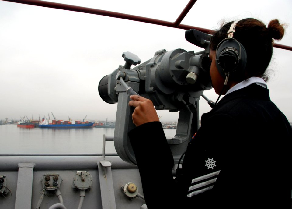 US Navy 070702-N-4021H-018 Quartermaster Seaman Salome Jeronimo looks through the big eyes while USS Pearl Harbor (LSD 52) moors in Peru during Partnership of the Americas (POA) 2007