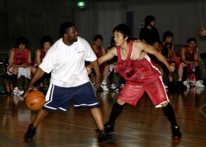 US Navy 070702-N-4649C-090 Storekeeper 2nd Class David Clark, a Sailor stationed aboard guided-missile destroyer USS John S. McCain (DDG 56), participates in a basketball game