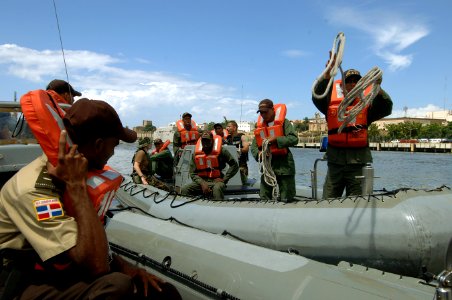 US Navy 070704-N-0989H-083 U.S. service members from the Navy Expeditionary Training Command and the Coast Guard International Training Division conduct towing drills with Dominican Republic soldiers and Port Authority personne photo