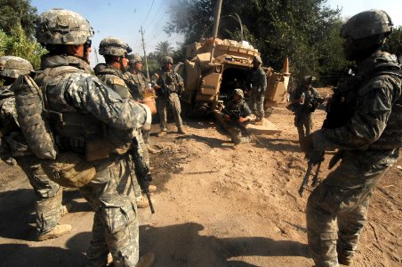 US Navy 070702-N-5555T-009 U.S. Army Soldiers from 2nd Platoon, Bravo Company, 1st Battalion, 30th Infantry Regiment, receive a briefing about a high-value target in the Arab Jabour region of Iraq