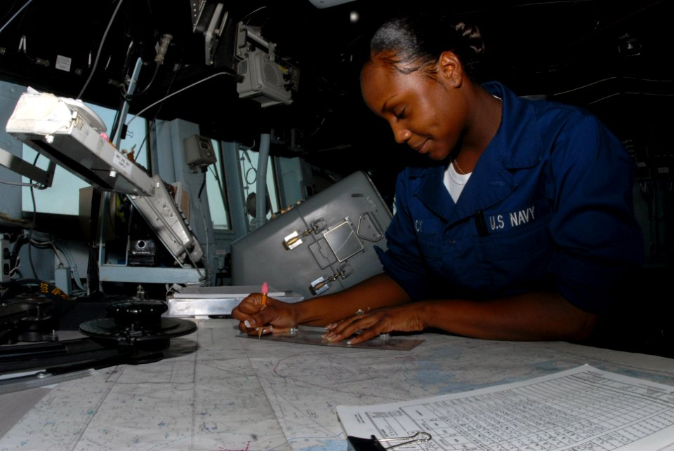 US Navy 070629-N-7498L-035 Quartermaster Seaman Antonia Mack plots navigational positing on the bridge aboard guided-missile destroyer USS O'Kane (DDG 77)