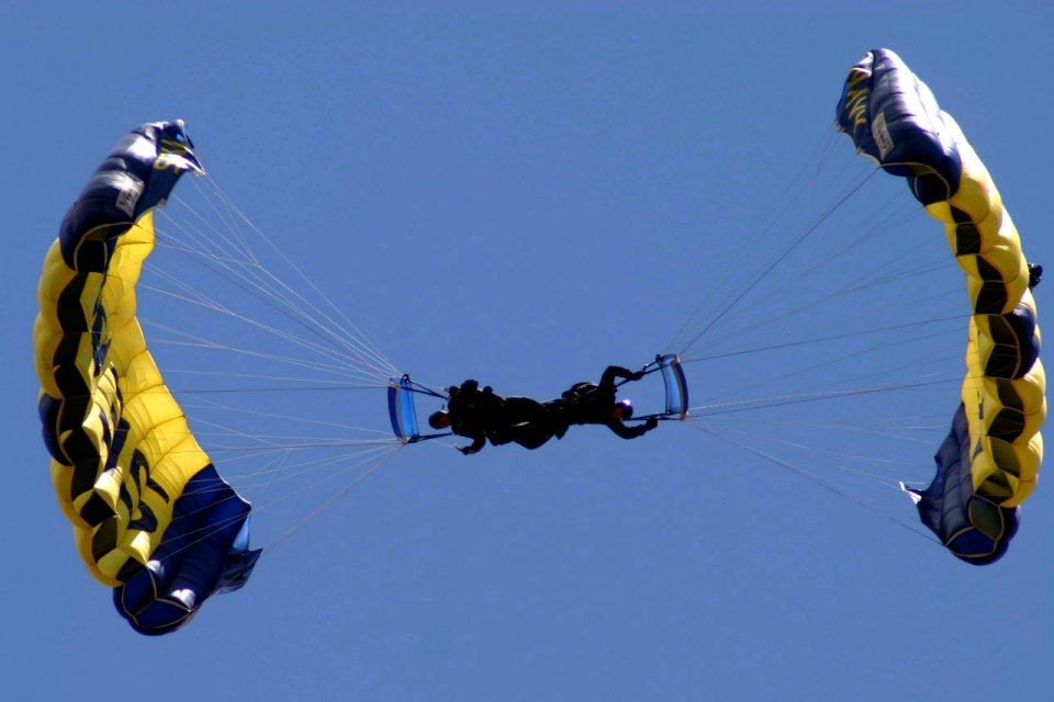 US Navy 070701-N-8110K-007 Two members of the Navy Parachute Team Leap Frogs perform their trademark downplane maneuver while performing for the first time in history at Boston's Fenway Park