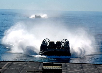 US Navy 070702-N-6710M-034 A landing craft air cushion (LCAC) prepares to enter the well deck of dock landing ship USS Tortuga (LSD 46) while carrying supplies and cargo from the 31st Marine Expeditionary Unit photo