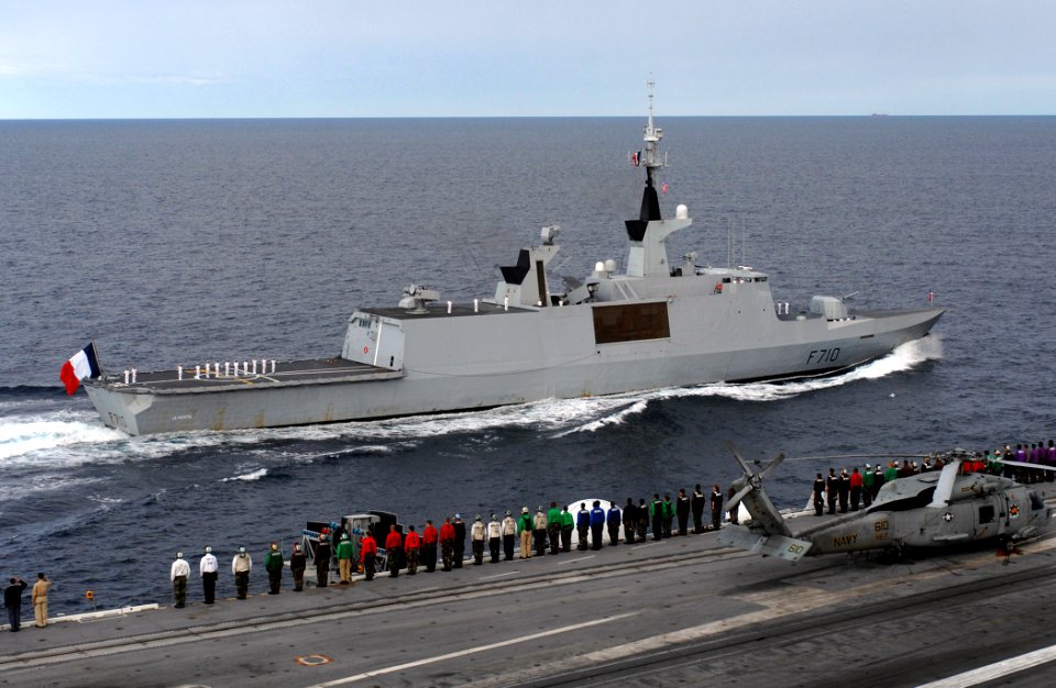 US Navy 070704-N-2984R-002 Sailors aboard Nimitz-class aircraft carrier USS Harry S. Truman (CVN 75) render honors to French frigate La Fayette (F-710)