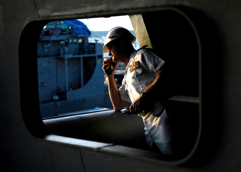 US Navy 070630-N-1229B-042 The ships first lieutenant, John Regelbrugge, oversees the mooring operations as USS Abraham Lincoln (CVN 72) pulls into her homeport at Naval Station Everett