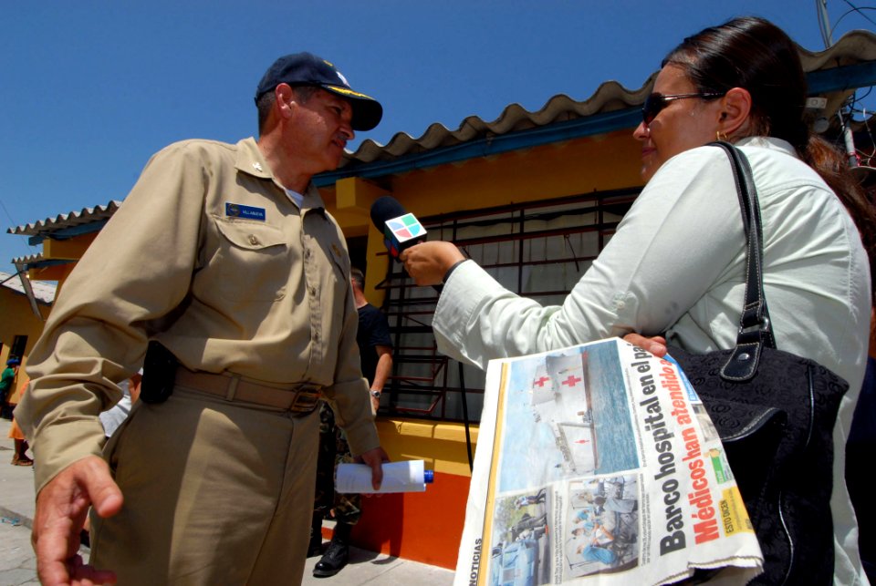 US Navy 070630-N-8704K-067 Capt. Amilcar Villanueva, attached to the Military Sealift Command hospital ship USNS Comfort (T-AH 20), is interviewed by local media at Medical Center Morales