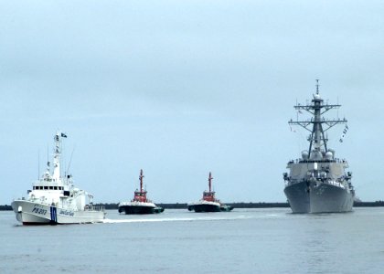 US Navy 070630-N-4649C-001 eigh Burke-class guided-missile destroyer USS John S. McCain (DDG 56) arrives for a scheduled port visit escorted by the Japanese coast guard and local harbor tugs photo