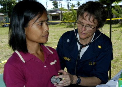US Navy 070702-N-1752H-182 Cmdr. Cindy Tamminga performs a routine check up for a local patient during a medical civic affairs program (MEDCAP) held at Tabaco Elementary School