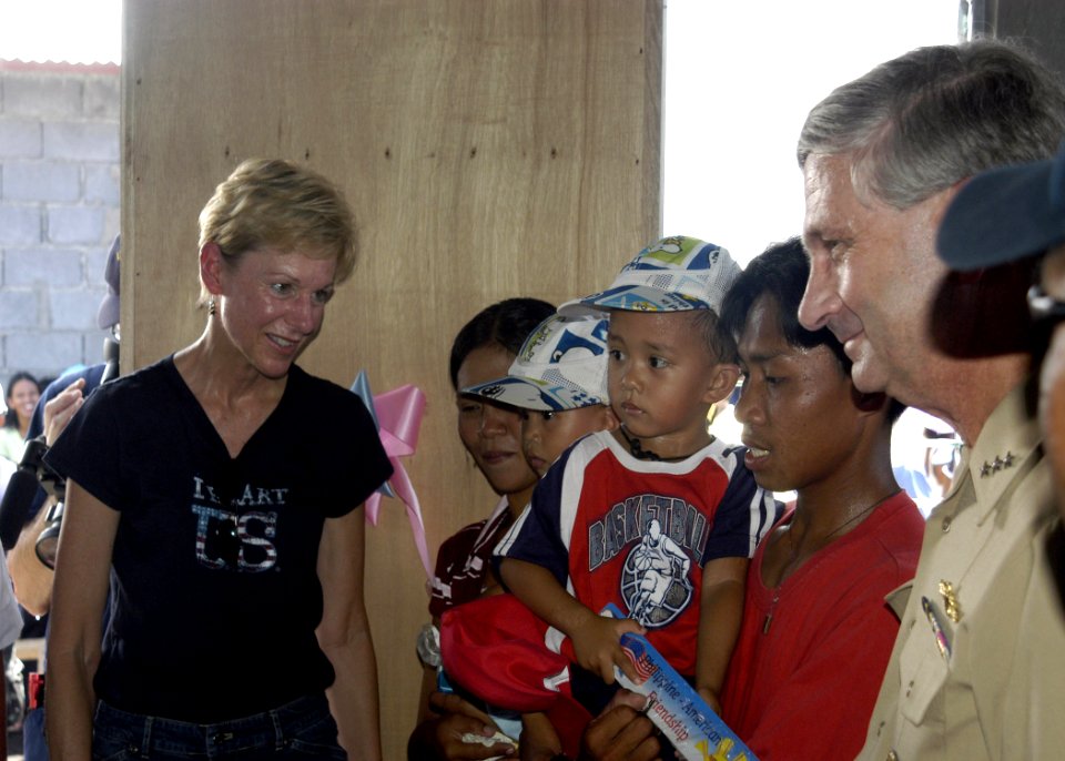 US Navy 070704-N-6410J-048 U.S. Ambassador to the Philippines, the Honorable Kristie A. Kenney is joined by Vice Adm. Doug Crowder as she speaks to a family who will move into one of 35 homes built in support of Pacific Partner