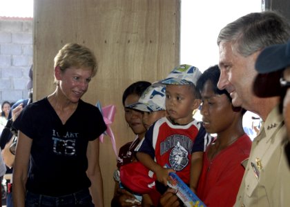 US Navy 070704-N-6410J-048 U.S. Ambassador to the Philippines, the Honorable Kristie A. Kenney is joined by Vice Adm. Doug Crowder as she speaks to a family who will move into one of 35 homes built in support of Pacific Partner