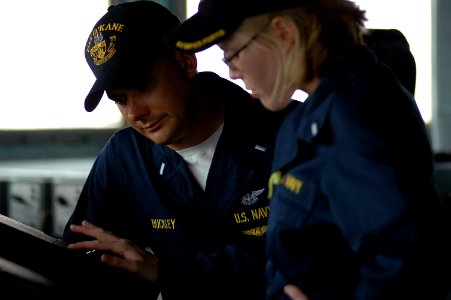 US Navy 070702-N-7498L-033 Lt. j.g. Richard Buckley, left, assists officer of the deck Lt j.g. Devon Willett by monitoring radar surface contacts from the bridge aboard guided-missile destroyer USS O'Kane (DDG 77)