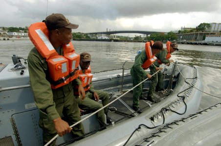 US Navy 070704-N-0989H-078 U.S. service members from the Navy Expeditionary Training Command and the Coast Guard International Training Division conduct towing drills with Dominican Republic soldiers and Port Authority personne photo