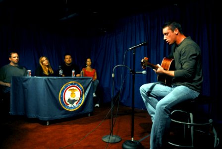 US Navy 070704-N-0684R-039 Aviation Structural Mechanic (Equipment) 3rd Class Sam Logiudice performs in front of studio judges during the Stennis Idol contest aboard Nimitz-class aircraft carrier USS John C. Stennis (CVN 74)