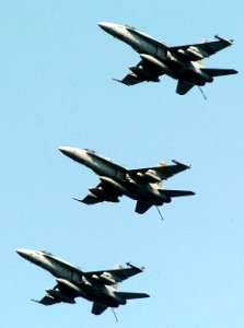 US Navy 070704-N-3038W-196 Three F-A-18C Hornets from three different squadrons assigned to Carrier Air Wing 9 fly in formation above Nimitz-class aircraft carrier USS John C. Stennis (CVN 74)