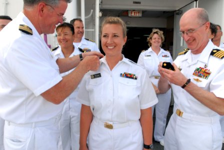 US Navy 070703-N-4238B-045 Capt. Bruce Boynton, Medical Treatment Facility commanding officer, promote PHS Lt. Cmdr. Jennifer Tredway, a surgical nurse attached to Comfort photo