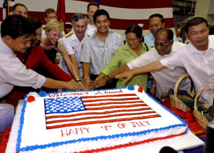 US Navy 070704-N-4954I-078 Vice Adm. Doug Crowder is joined by U.S. Ambassador to the Philippines, the Honorable Kristie A. Kenny and government officials from the Bicol region for a cake cutting during a 4th of July reception photo