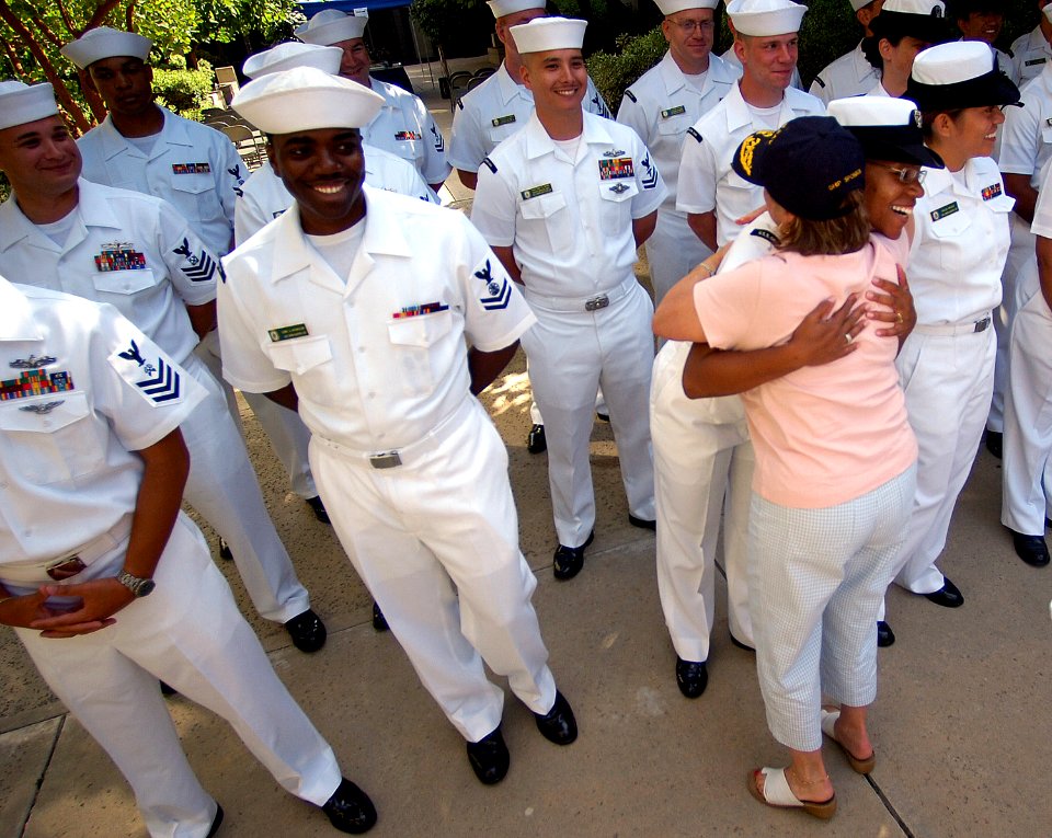 US Navy 070702-N-4163T-035 Mrs. Rose Magnus, ship's sponsor for Pre-commissioning Unit Green Bay (LPD 20), and wife of Assistant Commandant of the Marine Corps Gen. Robert Magnus, fulfills her promise to hug every Sailor attach