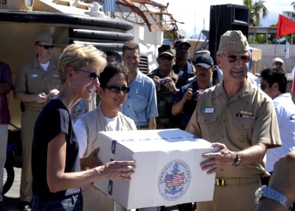 US Navy 070704-N-6410J-113 U.S. Ambassador to the Philippines, the Honorable Kristie A. Kenney and Vice Admiral Doug Crowder hand a box to a Philippine official during Project Handclasp ceremony