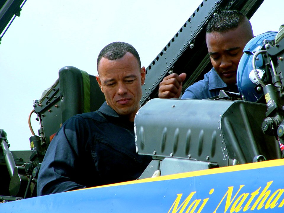 US Navy 070704-N-2888Q-006 Carl Mack, executive director of the National Society of Black Engineers, receives a safety briefing from Staff Sgt. Deo Harrypersaud, crew chief of the Blue Angels ^7 plane, prior to a VIP ride with
