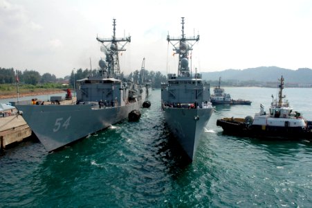 US Navy 070702-N-7783B-002 The guided missile frigate USS Jarrett (FFG 33) is guided into the port of Kemaman, alongside the guided missile frigate USS Ford (FFG 54)