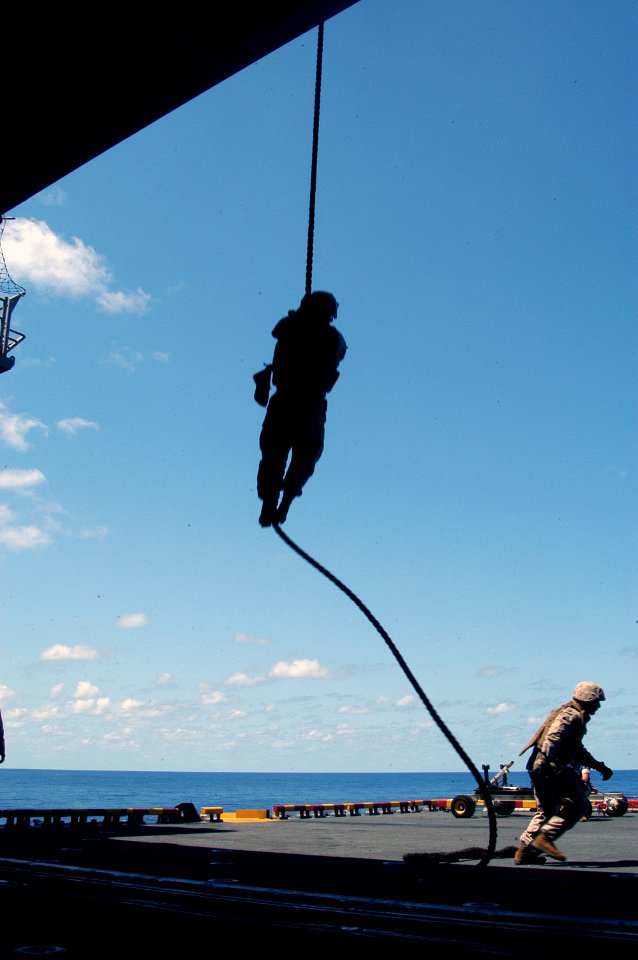 US Navy 070704-N-5642P-065 A U.S. Marine, from the 22nd Marine Expeditionary Unit (MEU), repels from the back of a CH-46 helicopter to the flight deck elevator aboard USS Kearsarge (LHD-3)