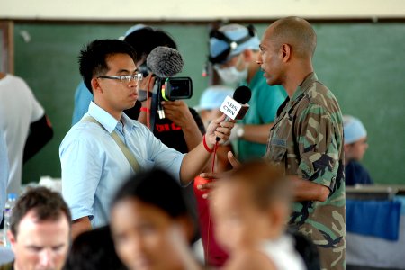 US Navy 070706-N-9421C-112 Air Force Maj. Benard Van Pelt interviews with a local Philippine television station about the medical and dental work for local residents at Gogon Elementary School