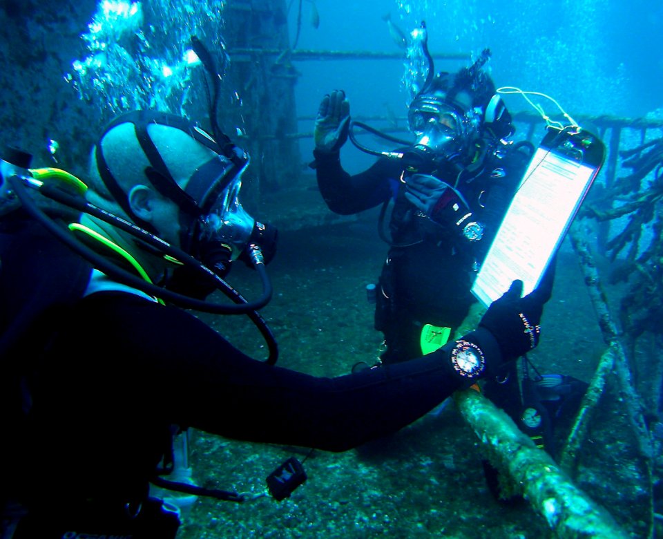 US Navy 070706-O-0000X-002 Personnel Specialist 1st Class Kevin Armold, attached on board Naval Air Station Pensacola, is reenlisted by Army Maj. Shean Phelps on the main deck of the newly sunken aircraft carrier USS Oriskany
