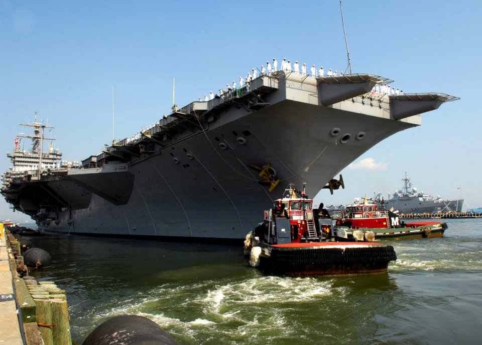 US Navy 070707-N-1713L-032 Tugboats assist USS Enterprise (CVN 65) as the ship departs Naval Station Norfolk for a scheduled deployment