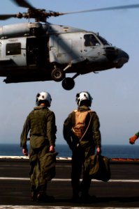 US Navy 070707-N-3038W-312 Aircrew attached to the Eightballers of Helicopter Anti-Submarine Squadron (HS) 8 watch an SH-60F Seahawk land on the flight deck of Nimitz-class aircraft carrier USS John C. Stennis (CVN 74)