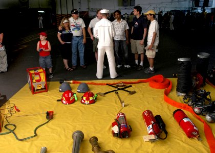 US Navy 070704-N-1229B-020 Damage Controlman Fireman Recruit Christopher Ritter describes what damage control equipment is used for on board Nimitz-class aircraft carrier USS Abraham Lincoln (CVN 72) photo