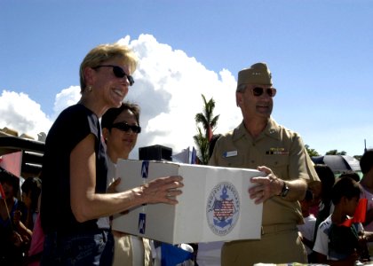 US Navy 070704-N-6410J-116 U.S. Ambassador to the Philippines, the Honorable Kristie A. Kenney and Vice Adm. Doug Crowder hand a box to a Philippine official during the Project Handclasp ceremony