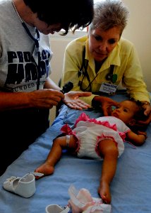 US Navy 070705-N-6278K-035 From left, Jean Muench and Diane Speranza, both of Project Hope, prepare to check an infant's vital signs at the Dr. Juan A. Nunez Policentro de Salud Hospital
