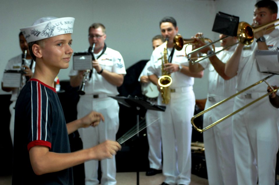 US Navy 070706-N-0194K-115 Matthew Giraldo, a music student at the Colon School for the Fine Arts, leads the Navy Show Band in a rendition of