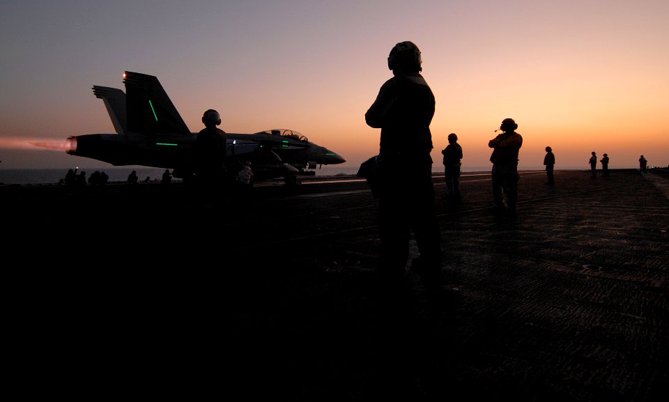 US Navy 070706-N-0684R-056 Flight deck personnel prepare to launch an F-A-18F Super Hornet assigned to the Black Knights of Strike Fighter Squadron (VFA) 154 from the flight deck of the Nimitz-class aircraft carrier USS John C