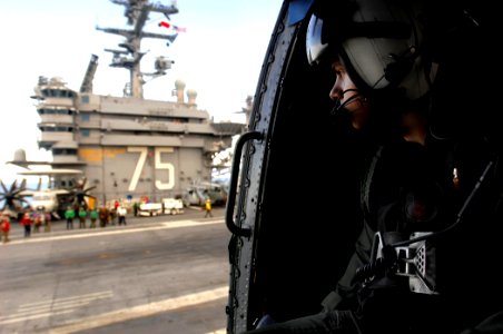 US Navy 070706-N-2984R-332 Aviation Warfare Systems Operator 2nd Class Justin Dove assigned to Anti-Submarine Helicopter Squadron (HS) 7 looks over the flight of USS Harry S. Truman (CVN 75)
