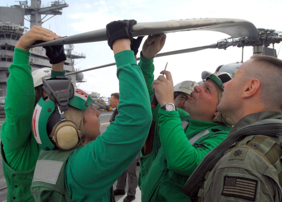 US Navy 070710-N-6854D-001 Sailors attached to the Red Lions of Helicopter Anti-Submarine Squadron (HS) 15 perform preflight operations on an SH-60F Seahawk on the flight deck aboard the Nimitz-class aircraft carrier USS Dwight