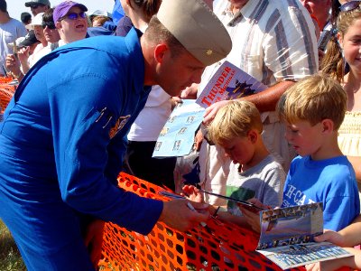 US Navy 070707-N-2888Q-001 Marine Corps Maj. Nathan Miller, a Blue Angels pilot, signs autographs for young fans following a performance at the Thunder Over Michigan Air Show