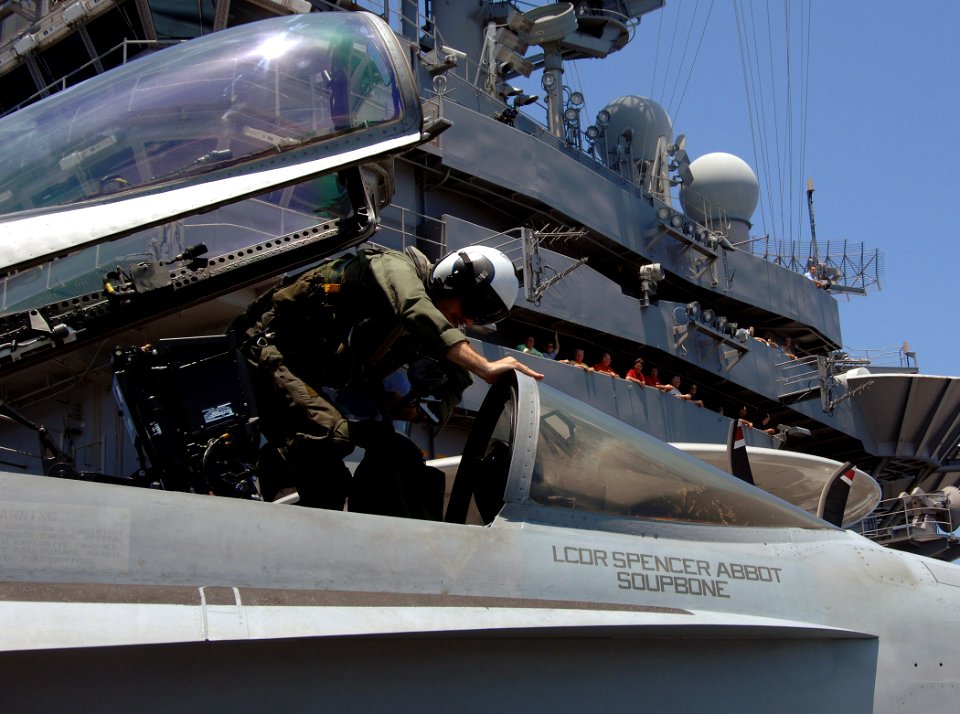 US Navy 070710-N-8923M-125 A Naval Aviator attached to the Raging Bulls of Strike Fighter Squadron (VFA) 37, climbs out from the cockpit of an F-A-18E Super Hornet on the flight deck aboard the Nimitz-class aircraft carrier USS