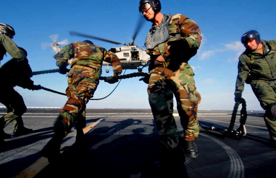 US Navy 070705-N-2984R-230 Sailors, assigned to Explosive Ordnance Disposal Unit (EODMU) 6 Det. 22, perform a fast rope exercise on the flight deck aboard Nimitz-class aircraft carrier USS Harry S. Truman (CVN 75)