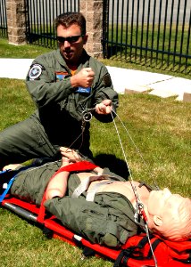 US Navy 070706-N-9860Y-025 Hospital Corpsman 1st Class Greg Highfill, of Cottonwood, Calif., gives search and rescue training on loading a casualty in a stretcher in preparation for a helicopter lift on board Naval Air Station