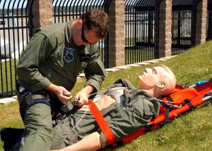 US Navy 070706-N-9860Y-039 Hospital Corpsman 2nd Class Andrew Peterson, of Littleton, Colo., attempts to load a casualty on a stretcher during search and rescue training on how to prepare a casualty for a helicopter lift on boa