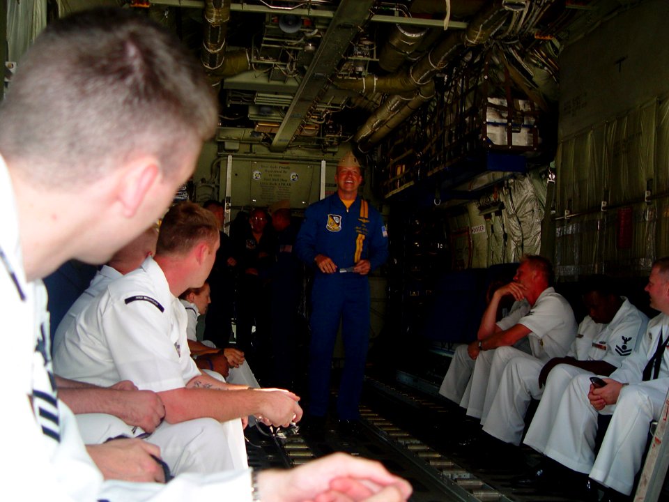 US Navy 070706-N-2888Q-001 Maj. Matt McGath briefs several Michigan recruiters before their flight on Fat Albert, the U.S. Marine Corps C-130 Hercules assigned to the Blue Angels