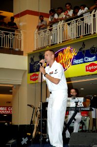 US Navy 070706-N-7783B-002 Musician 3rd Class Spence Haasenritter sings with 7th Fleet rock band Orient Express in front of a large crowd at the Kuantan Parade Mall during the Malaysian phase of exercise Cooperation Afloat Read