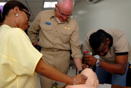 US Navy 070707-N-4238B-078 Cmdr. Joe Burkard, an anesthesiologist attached to Military Sealift Command hospital ship USNS Comfort (T-AH 20), guides Isai Romano, an emergency room doctor at Amador Guerrero Hospital photo