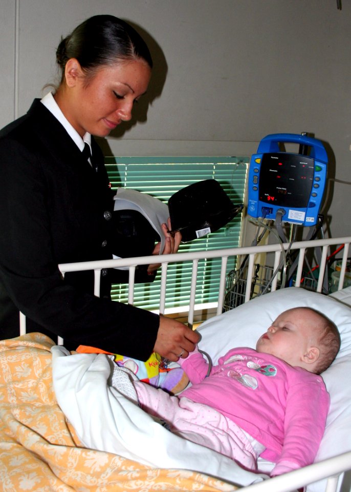 US Navy 070707-N-6710M-029 Seaman Francheska K. Montoya spends a few moments with a child at Sydney's Children's Hospital during a community relations project as part of a four-day port visit by dock landing ship