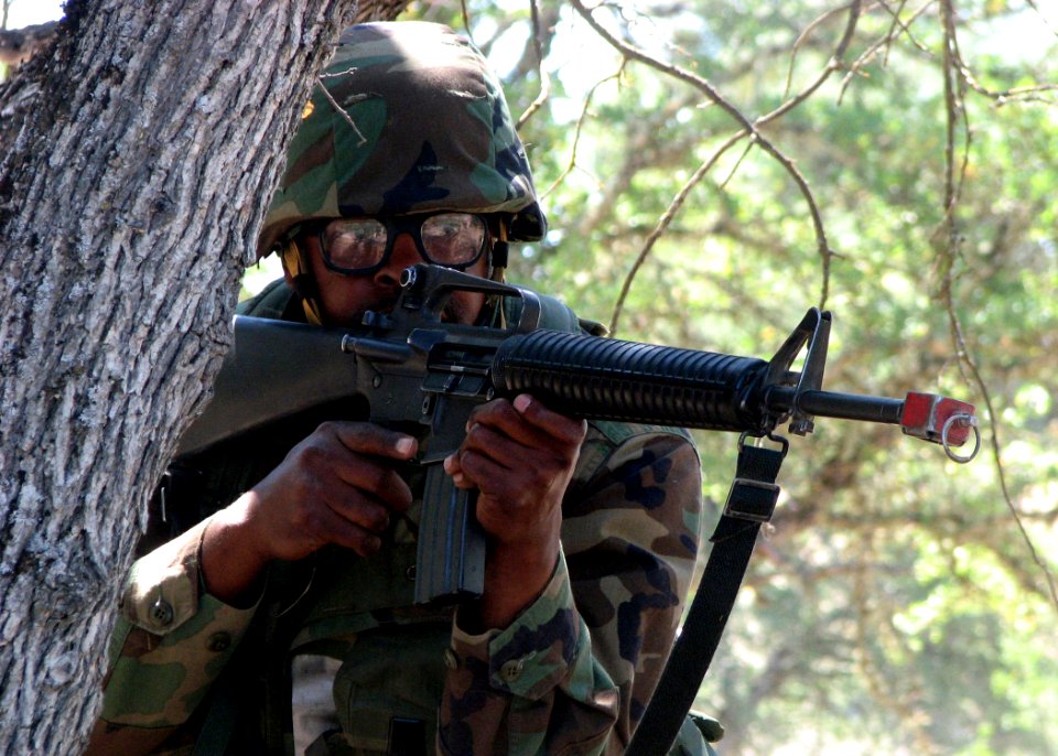 US Navy 070713-N-8547M-069 Culinary Specialist 1st class Derrick R. Wilson, of Naval Mobile Construction Battalion (NMCB) 5, takes cover during a reconnaissance patrol during a field exercise (FEX)