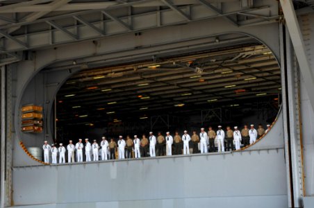 US Navy 070707-N-1713L-022 Sailors and Marines man the rails inside the hangar bay while preparing for USS Enterprise (CVN 65) to get underway